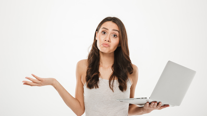 Женщина с недоумением держит планшет и разводит рукой
